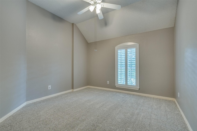 unfurnished room with ceiling fan, carpet floors, and lofted ceiling