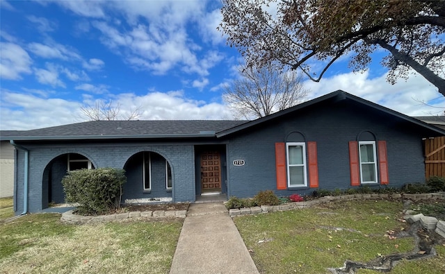 ranch-style home with a front lawn