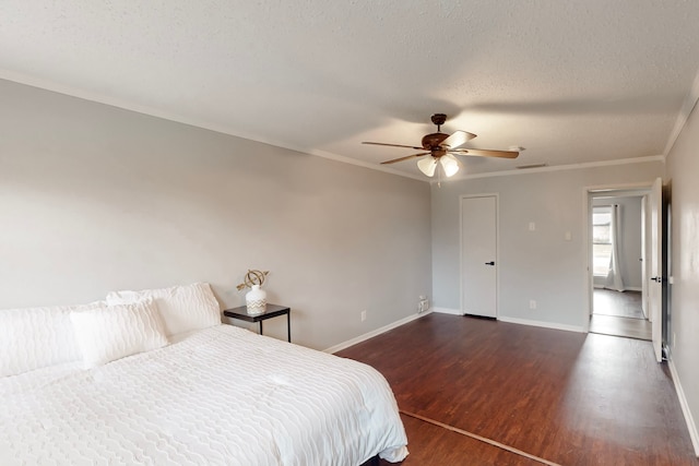 1721 Melrose St, Garland, TX 75042 - bedroom with ornamental molding, a textured ceiling, baseboards, and wood finished floors