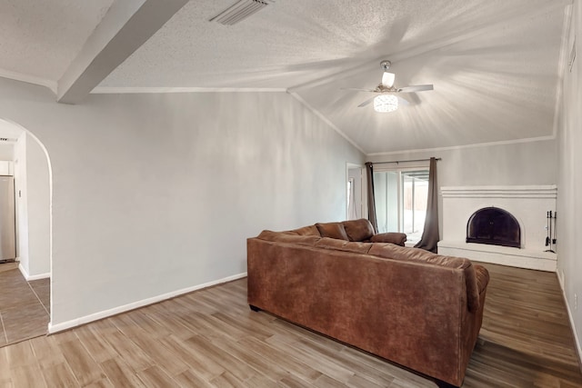 living room with hardwood / wood-style flooring, lofted ceiling with beams, and a textured ceiling