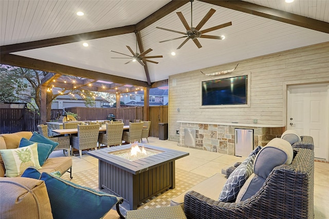 view of patio / terrace featuring a playground, an outdoor living space with a fire pit, and ceiling fan