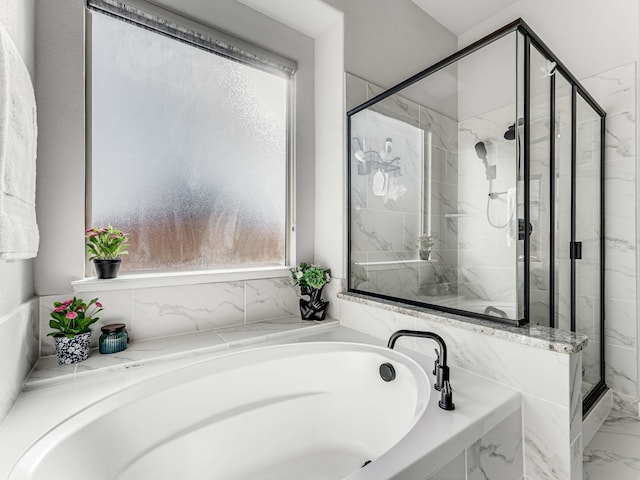 bathroom featuring shower with separate bathtub