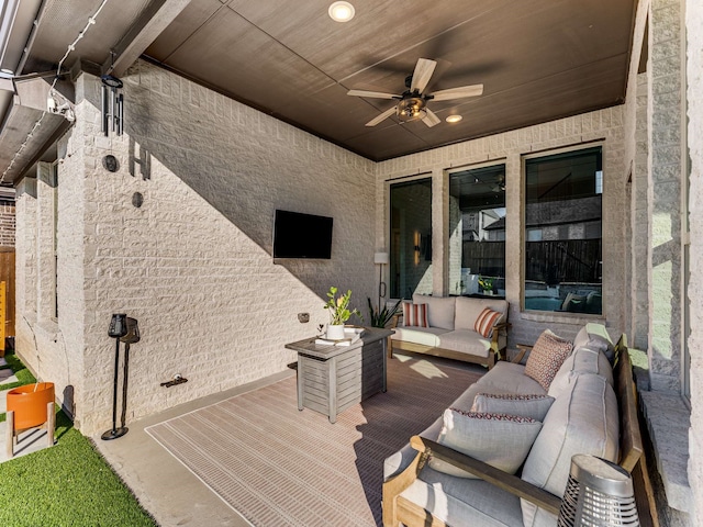 wooden deck with outdoor lounge area and ceiling fan