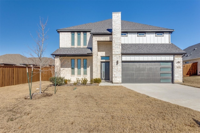 view of front of house featuring a garage and a front lawn