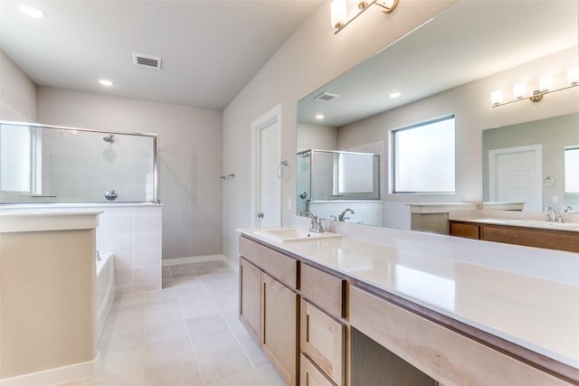 bathroom with tile patterned flooring, vanity, and separate shower and tub