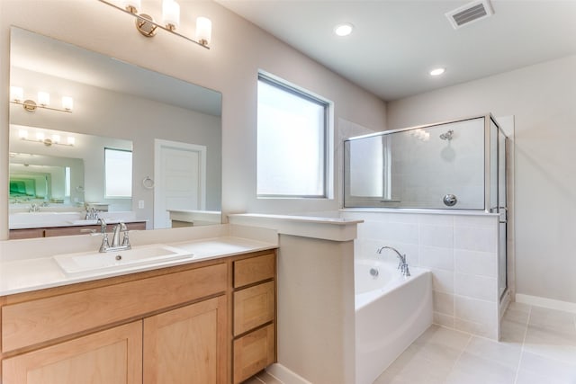 bathroom featuring vanity, plus walk in shower, and tile patterned flooring