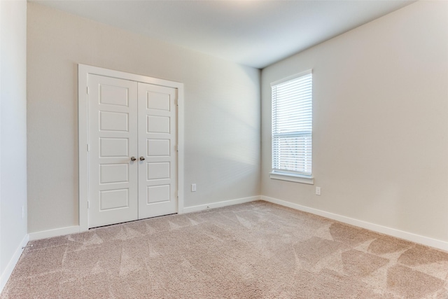 empty room with light colored carpet