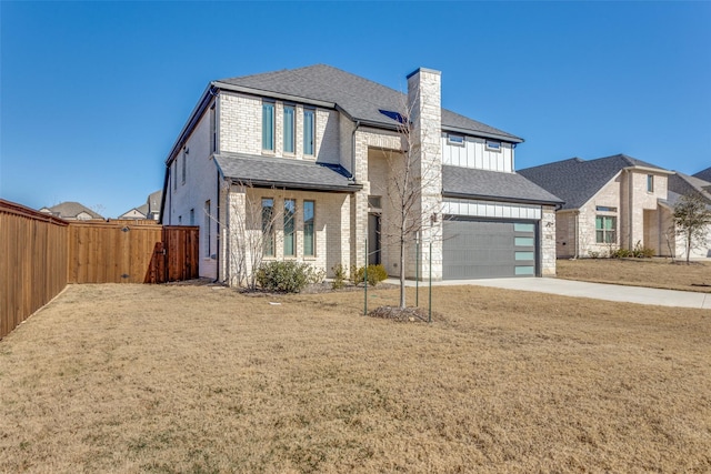 view of front of home featuring a garage and a front lawn