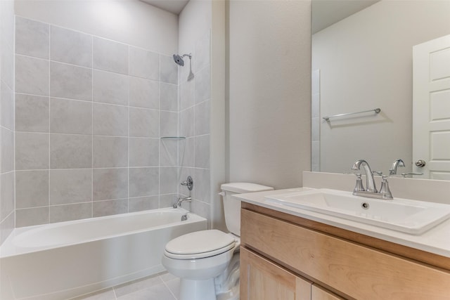 full bathroom with tile patterned flooring, vanity, tiled shower / bath combo, and toilet