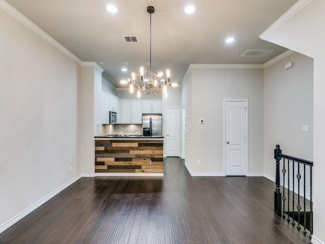 living room with dark hardwood / wood-style flooring, a chandelier, and ornamental molding