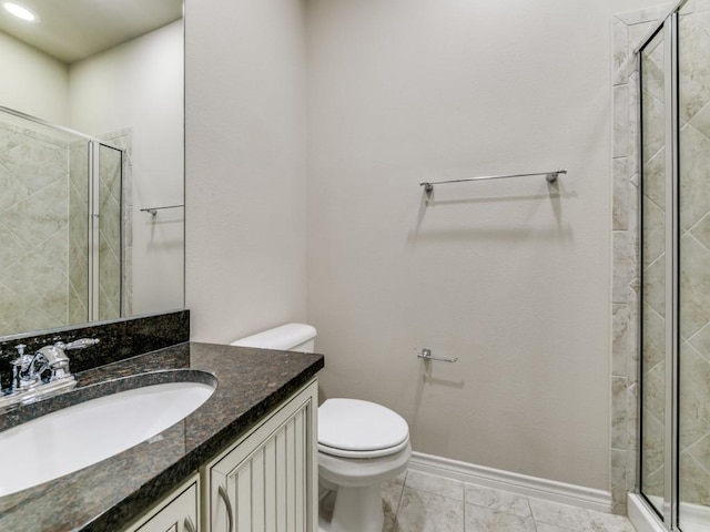 bathroom with vanity, toilet, and walk in shower