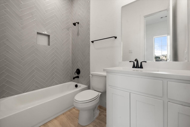 full bathroom with tiled shower / bath combo, wood-type flooring, vanity, and toilet