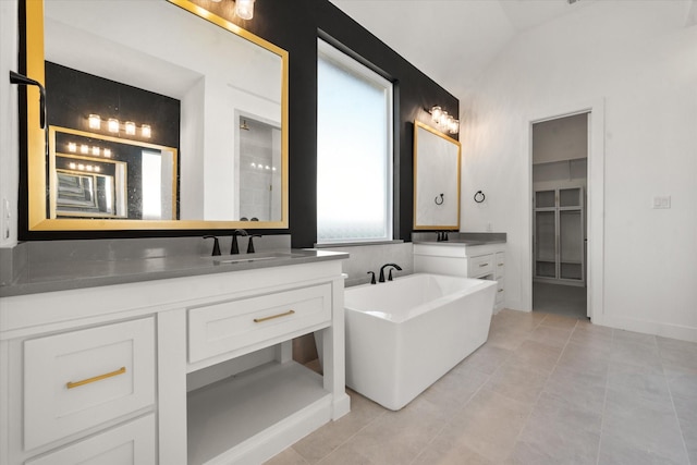 bathroom featuring vanity, a wealth of natural light, tile patterned floors, and vaulted ceiling