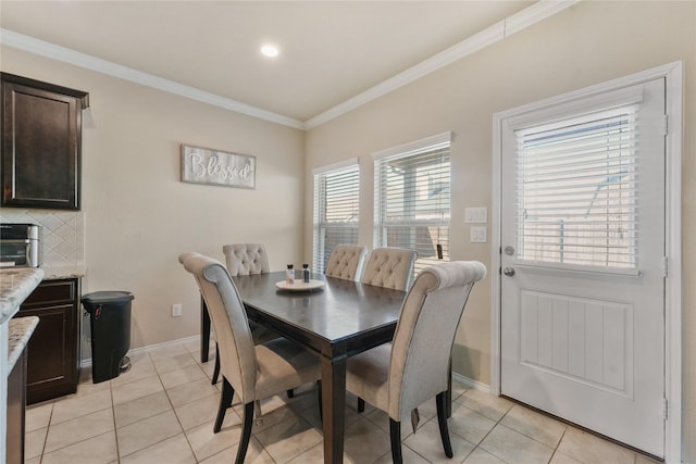 dining area featuring light tile patterned floors and ornamental molding