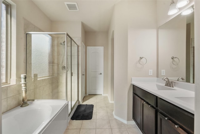 bathroom featuring tile patterned floors, plus walk in shower, and vanity