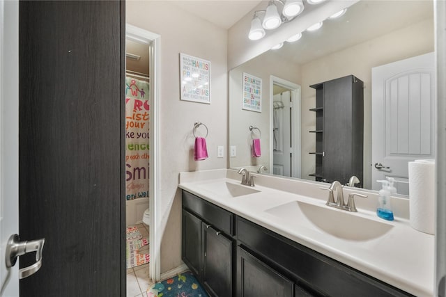 bathroom with vanity, toilet, and tile patterned flooring