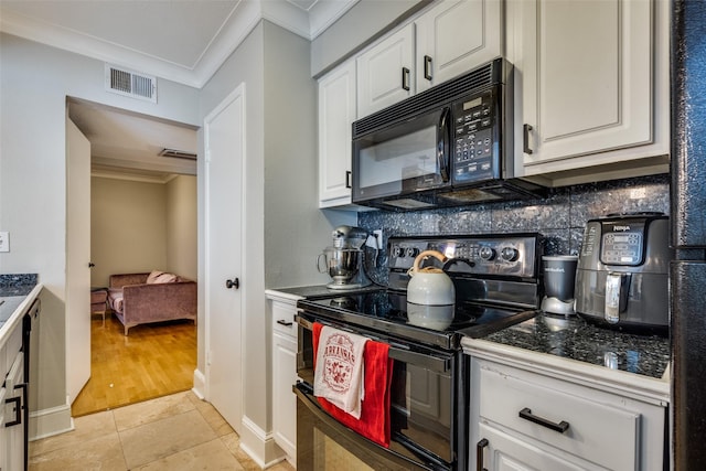 kitchen with black appliances, light tile patterned floors, ornamental molding, white cabinets, and backsplash