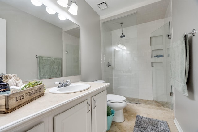 bathroom with vanity, a shower with door, and toilet