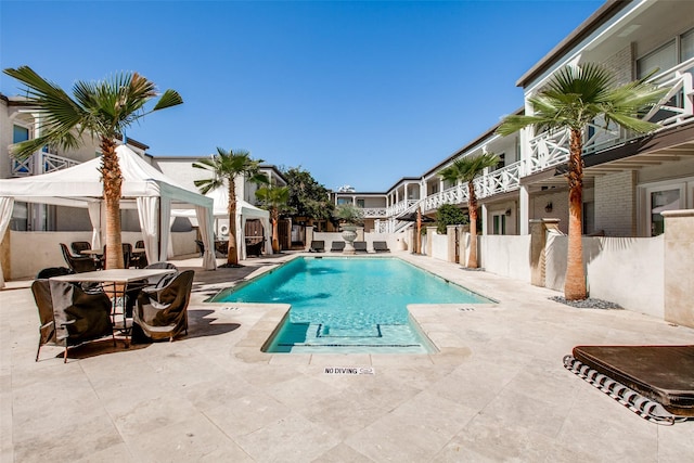 view of swimming pool with a gazebo and a patio area