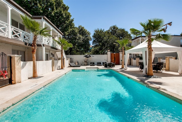 view of swimming pool featuring a gazebo and a patio