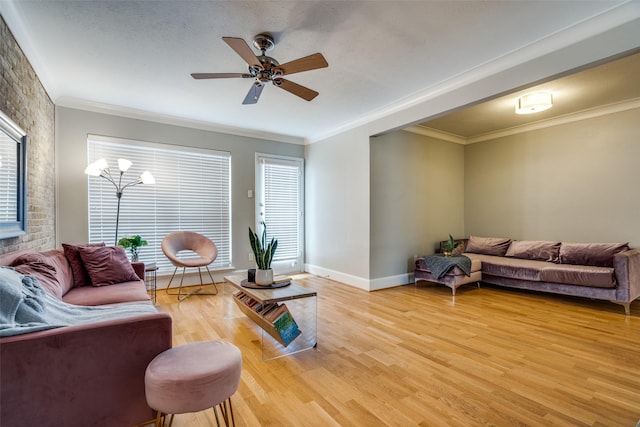 living room featuring crown molding, ceiling fan with notable chandelier, and hardwood / wood-style flooring