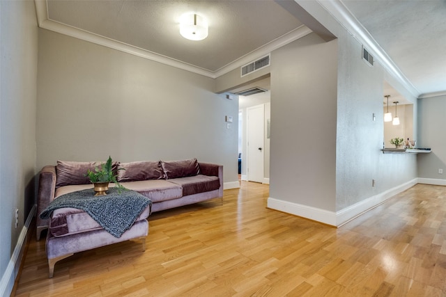 living room featuring hardwood / wood-style floors and ornamental molding