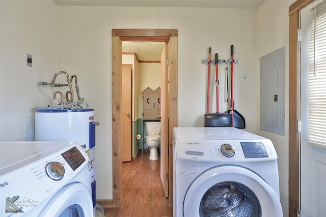 washroom with hardwood / wood-style flooring, electric panel, and independent washer and dryer