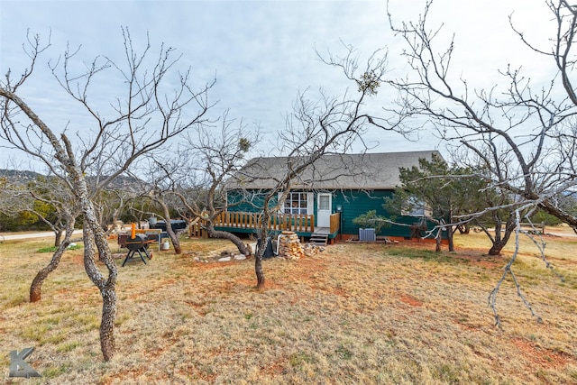 rear view of property with a lawn