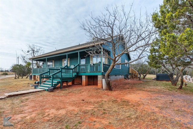 exterior space featuring a yard and stairs