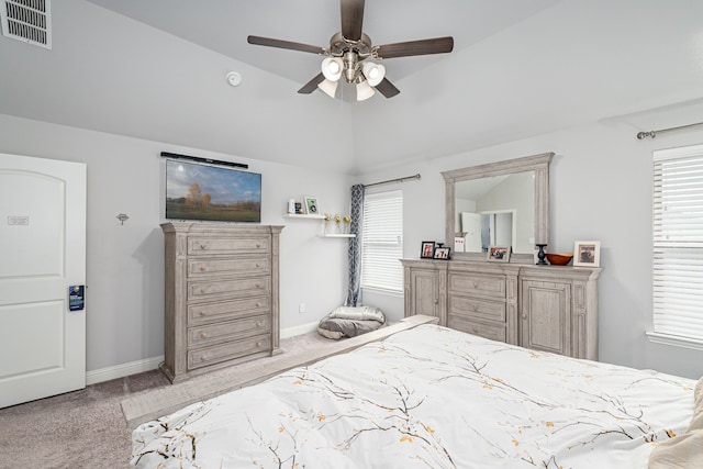 carpeted bedroom with ceiling fan and vaulted ceiling