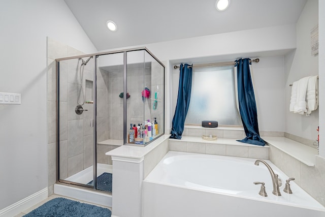 bathroom featuring separate shower and tub and lofted ceiling