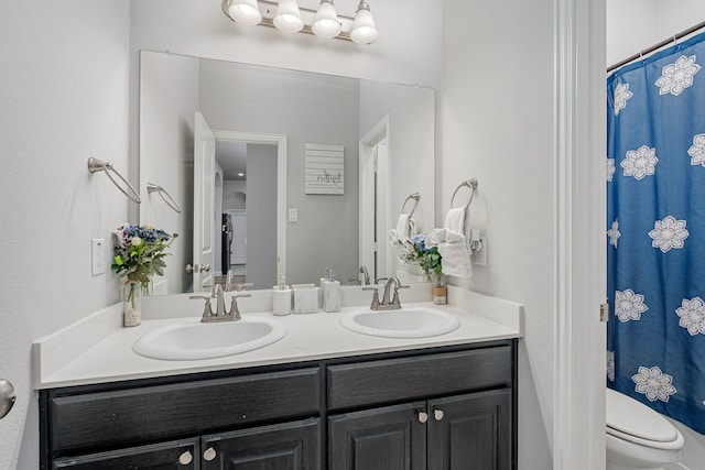 bathroom featuring vanity and toilet