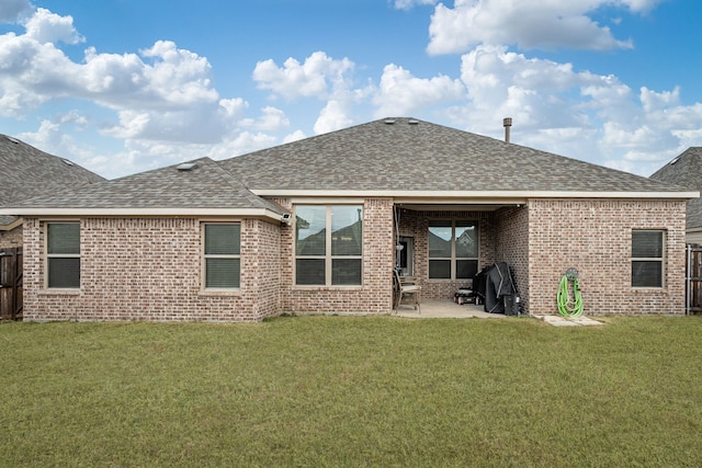 rear view of property featuring a lawn and a patio