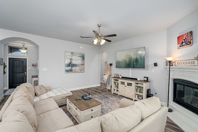 living room featuring ceiling fan and hardwood / wood-style floors