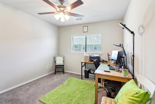 carpeted office featuring ceiling fan