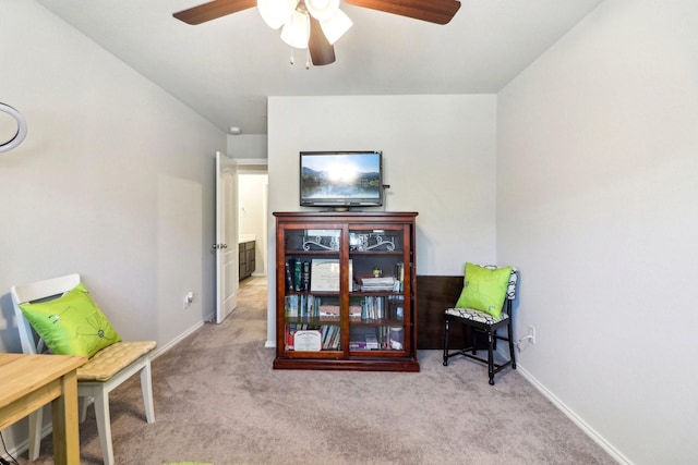 living area with ceiling fan and light carpet