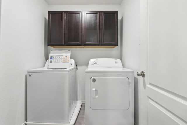 washroom with cabinets and independent washer and dryer