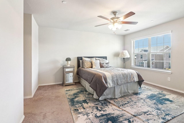 bedroom with ceiling fan and light colored carpet