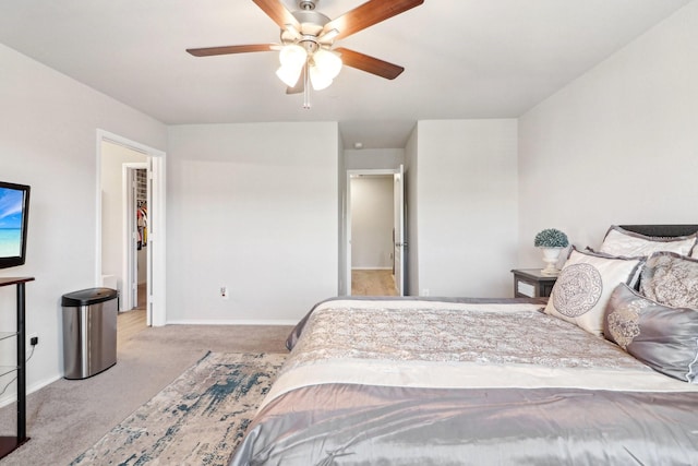 carpeted bedroom featuring ceiling fan and a spacious closet