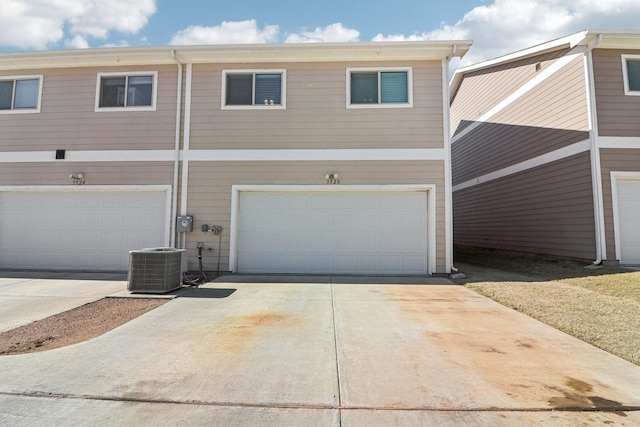 view of front of house with central AC and a garage