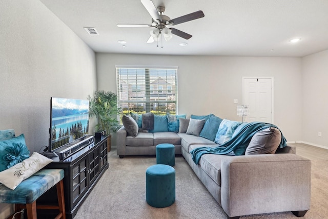 living room featuring light carpet and ceiling fan