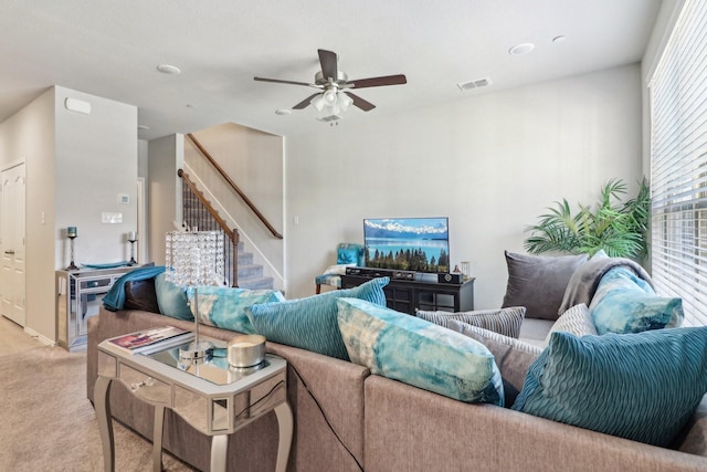 carpeted living room with ceiling fan