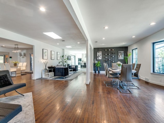 dining space featuring an inviting chandelier and dark wood-type flooring