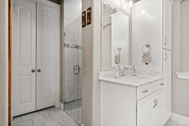 bathroom with a shower with shower door and vanity