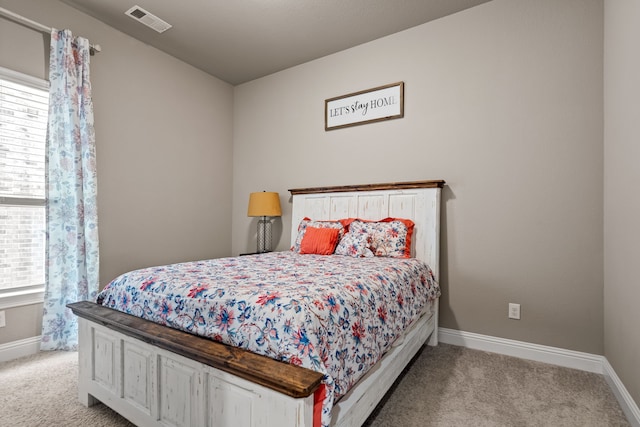 carpeted bedroom featuring multiple windows