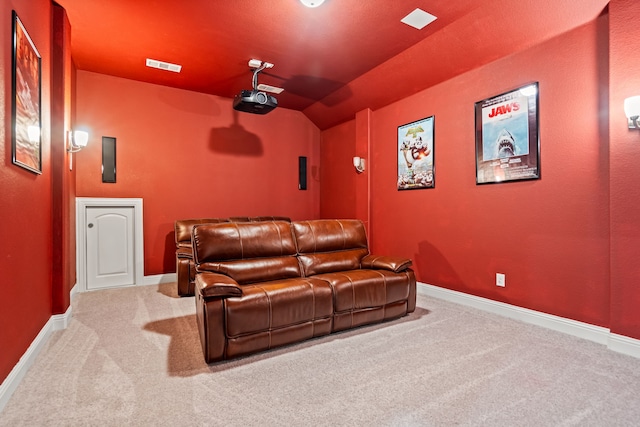 cinema room with light colored carpet and lofted ceiling