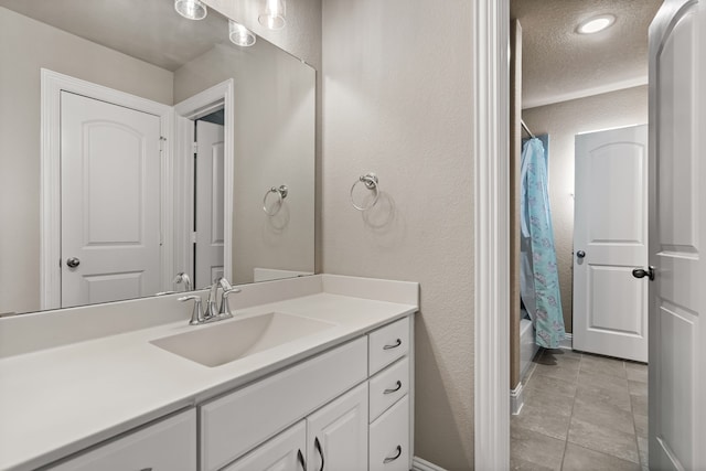 bathroom with vanity, tile patterned floors, shower / bath combo, and a textured ceiling