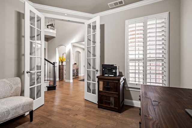 interior space with french doors, hardwood / wood-style floors, and crown molding