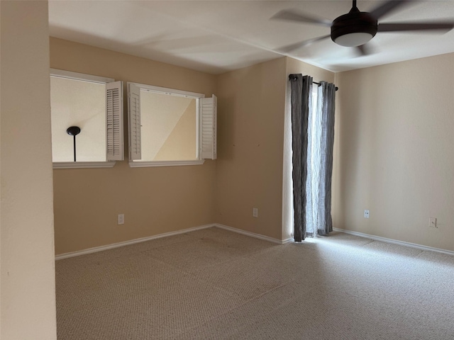 empty room with light colored carpet and ceiling fan