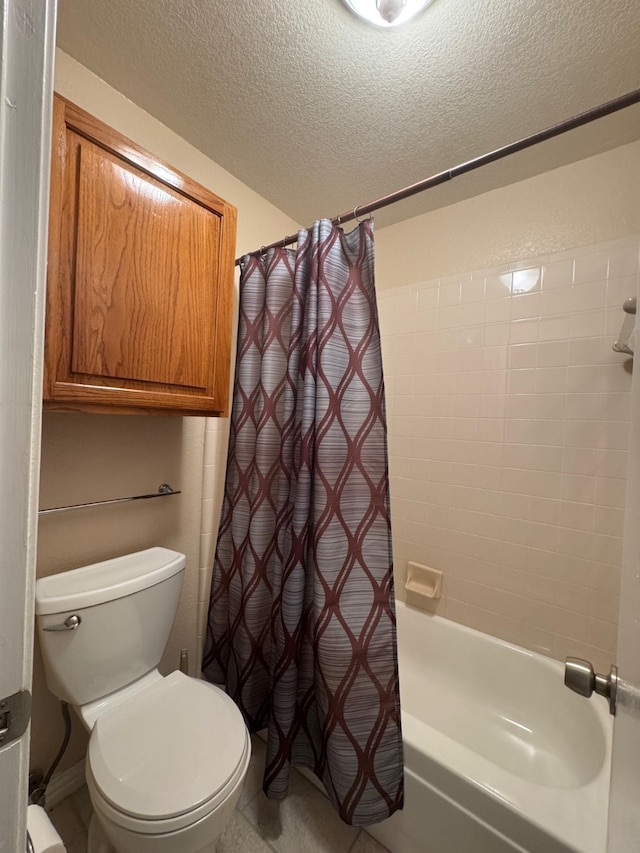 bathroom featuring toilet, a textured ceiling, and shower / bath combo with shower curtain